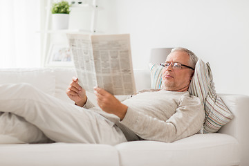 Image showing senior man reading newspaper at home