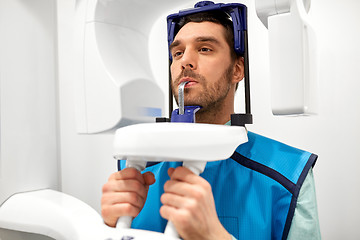 Image showing patient having x-ray scanning at dental clinic