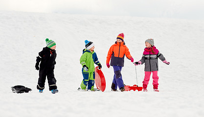 Image showing happy little kids with sleds sledging in winter