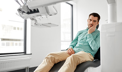 Image showing patient suffering from toothache at dental clinic