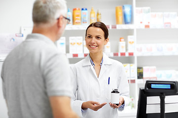 Image showing apothecary and senior customer at pharmacy