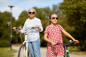 Image showing grandmother and granddaughter with bicycles