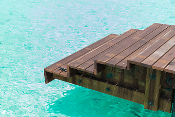 Image showing wooden pier with stair in sea water