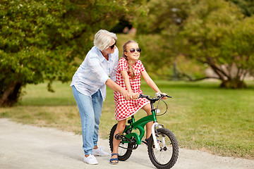 Image showing grandmother and granddaughter with bicycles