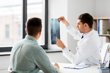 Image showing doctor showing x-ray to patient at hospital