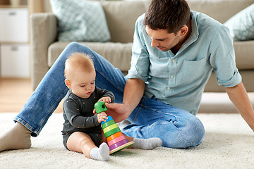 Image showing father playing with little baby daughter at home