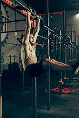 Image showing Concept: power, strength, healthy lifestyle, sport. Powerful attractive muscular man at gym