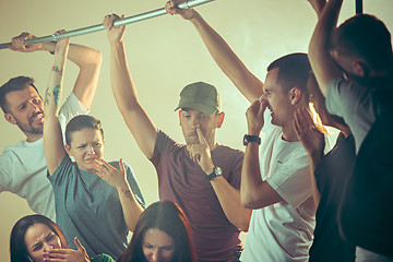 Image showing Sweaty armpits. Sweaty man. Bus. Public transport. The unhappy people near man