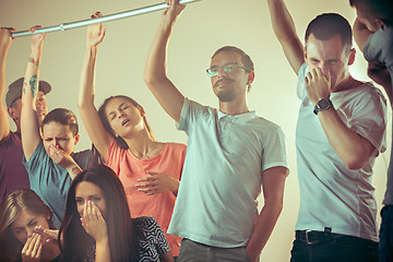 Image showing Sweaty armpits. Sweaty man. Bus. Public transport. The unhappy people near man