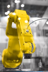 Image showing Automatic robot arm working in industrial environment