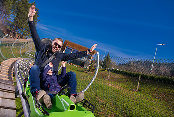 Image showing young father and son driving alpine coaster