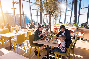 Image showing happy family enjoying lunch time together