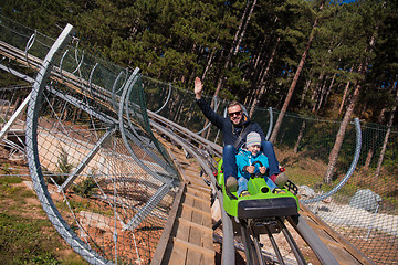 Image showing young father and son driving alpine coaster