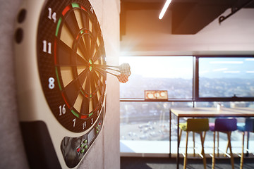 Image showing Darts arrow hitting in the target center