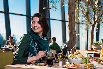 Image showing young woman  having lunch at restaurant