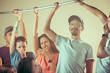 Image showing Sweaty armpits. Sweaty man. Bus. Public transport. The unhappy people near man