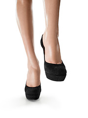 Image showing Tanned female legs in high heels isolated on white background.