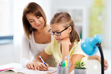 Image showing mother and daughter doing homework together