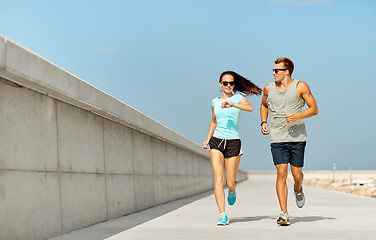 Image showing couple in sports clothes running outdoors