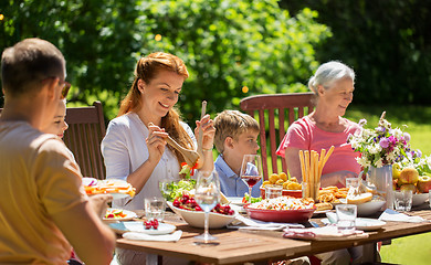 Image showing happy family having dinner or summer garden party