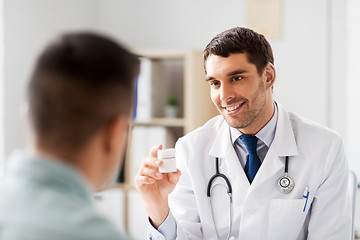 Image showing doctor showing medicine to patient at hospital