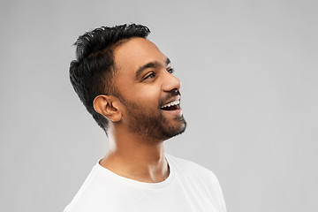 Image showing young laughing indian man over gray background