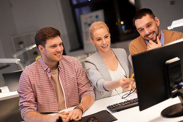 Image showing business team with computer working late at office