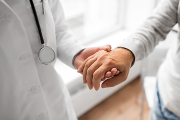 Image showing close up of doctor holding senior patient hand