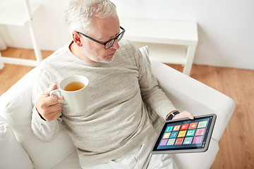 Image showing old man with smart home icons on tablet computer