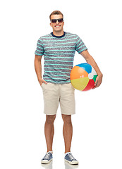 Image showing smiling young man in sunglasses with beach ball