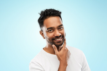 Image showing smiling indian man touching his beard