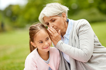 Image showing granddaughter sharing secrets with grandmother