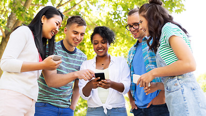 Image showing happy friends with smartphones at summer park