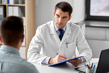 Image showing doctor with clipboard and male patient at hospital