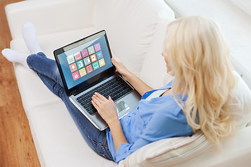 Image showing woman with smart home icons on laptop computer