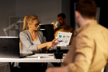 Image showing workers with user interface mockup at night office