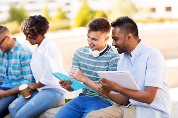 Image showing international students with notebooks outdoors