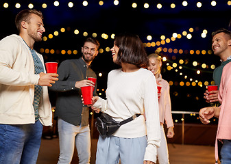 Image showing friends with drinks dancing at rooftop party