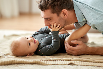 Image showing father playing with little baby daughter at home