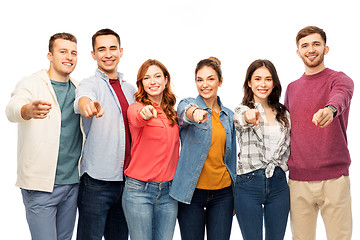 Image showing group of smiling friends pointing at you over