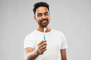 Image showing indian man with toothbrush over gray background