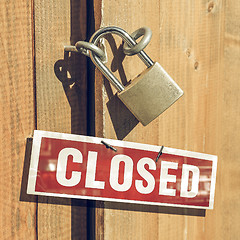 Image showing Vintage looking Padlock on a wood door with closed sign