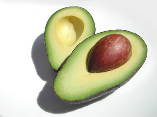 Image showing avocado cut in half on a white background