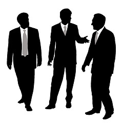 Image showing Group of three businessmen walking and talking