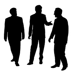 Image showing Group of three businessmen walking and talking
