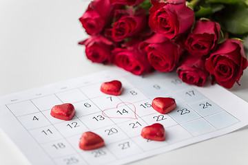 Image showing close up of calendar, heart, candies and red roses