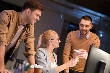 Image showing business team with coffee working at night office