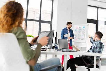 Image showing creative man showing user interface at office