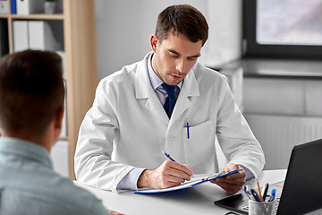 Image showing doctor with clipboard and male patient at hospital