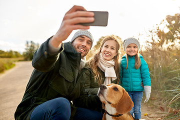 Image showing happy family with dog taking selfie in autumn